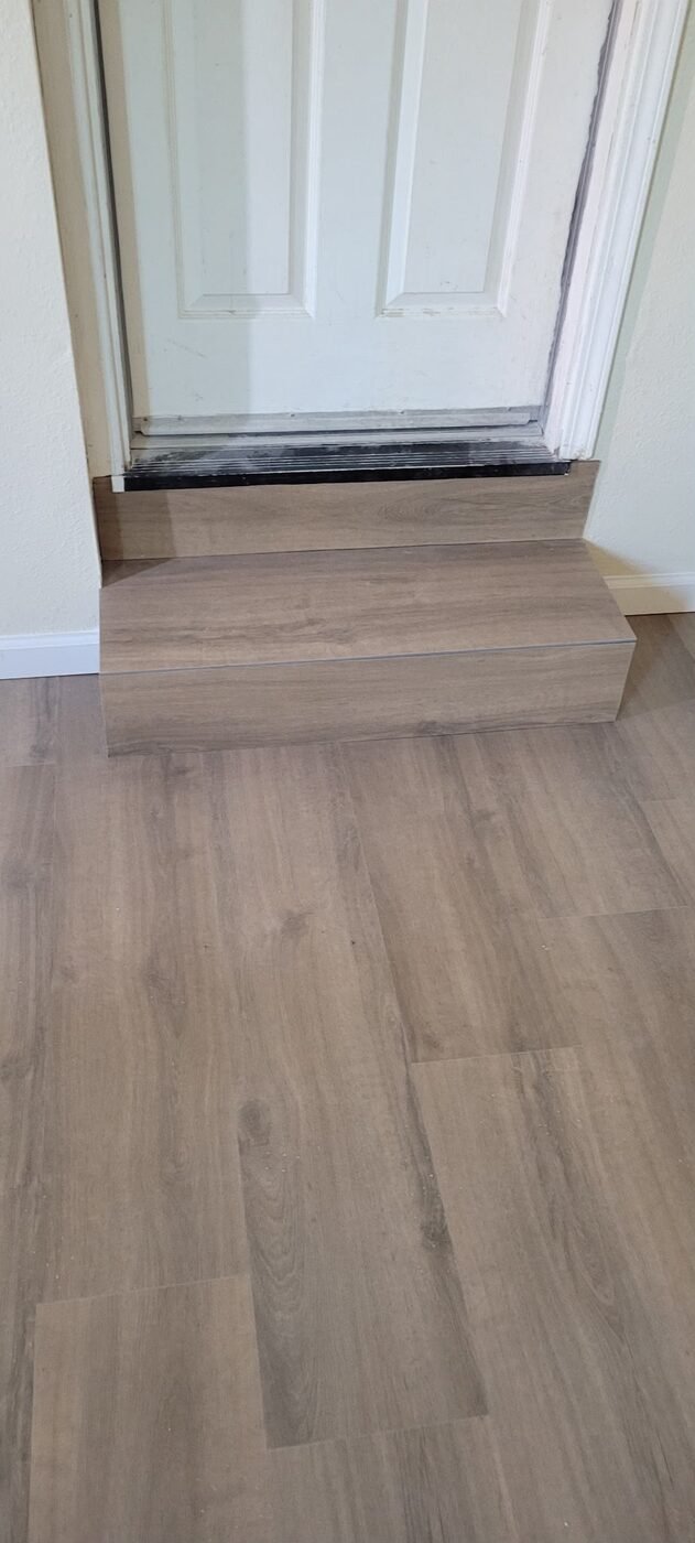 Finished vinyl plank flooring with step